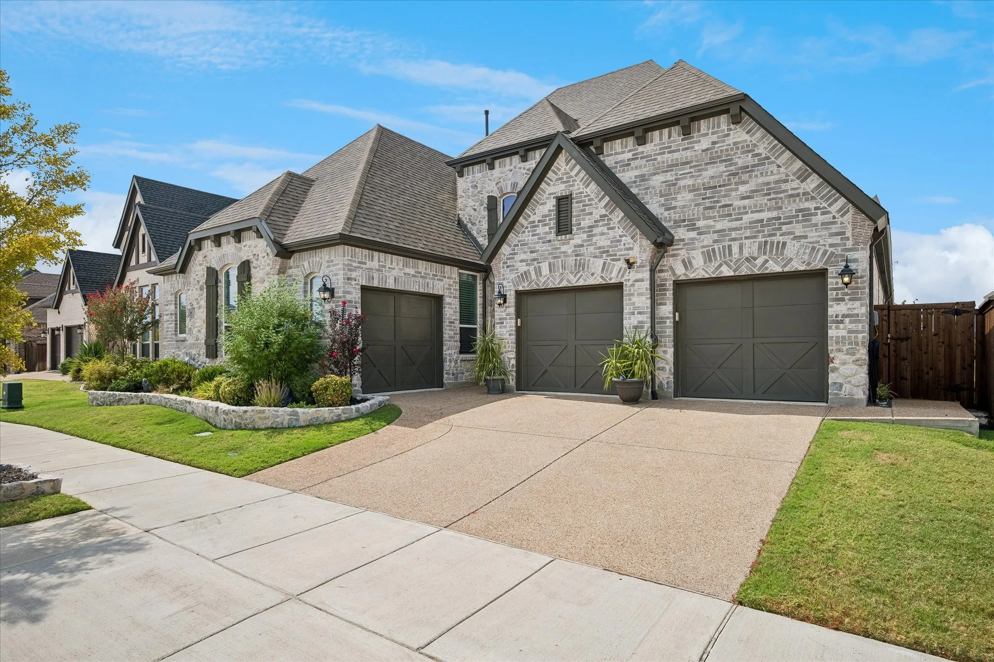 The three-car garage provides additional space for storage, a golf cart, or a third vehicle. 