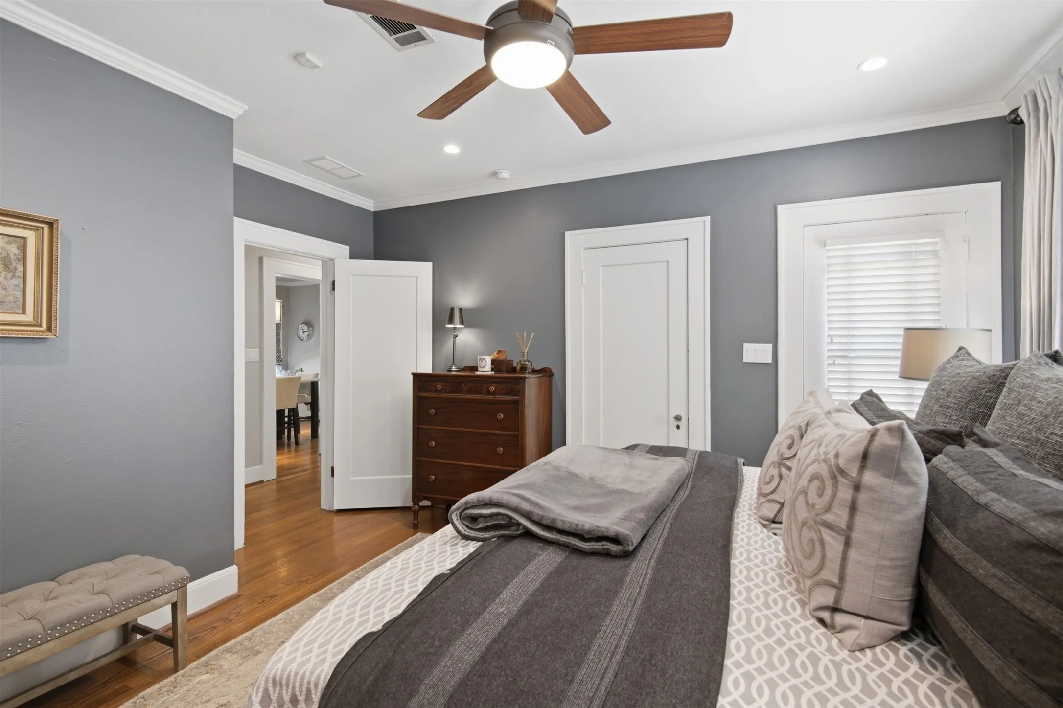 Hardwood flooring, recessed lighting, crown molding, ceiling fan, and original trim throughout