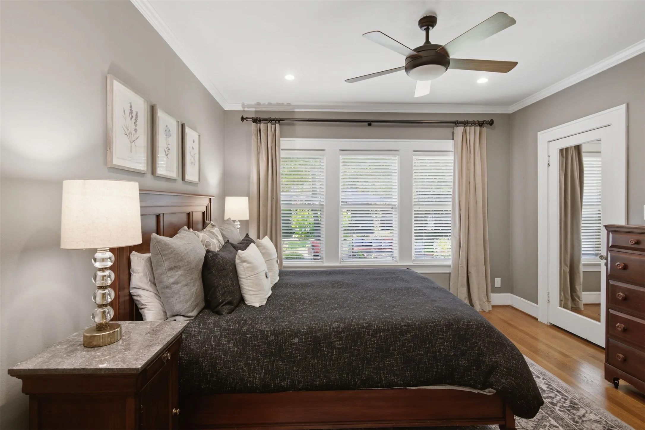 Third Bedroom - Hardwood flooring, crown molding, built-in ceiling fan, recessed lighting, and a window with blinds and drapery