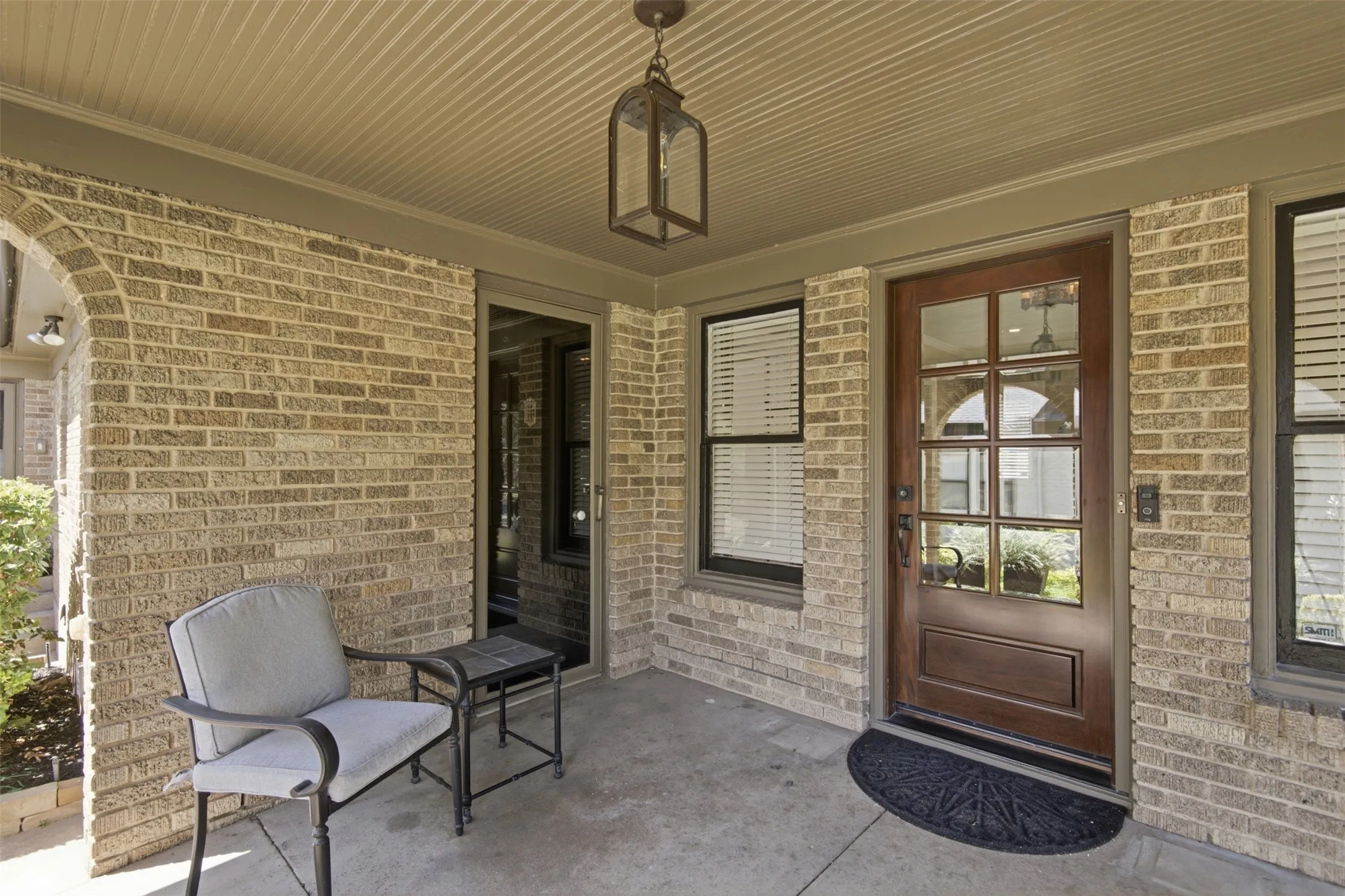 Paneled front door. Original secondary entrance door with vintage door peephole.