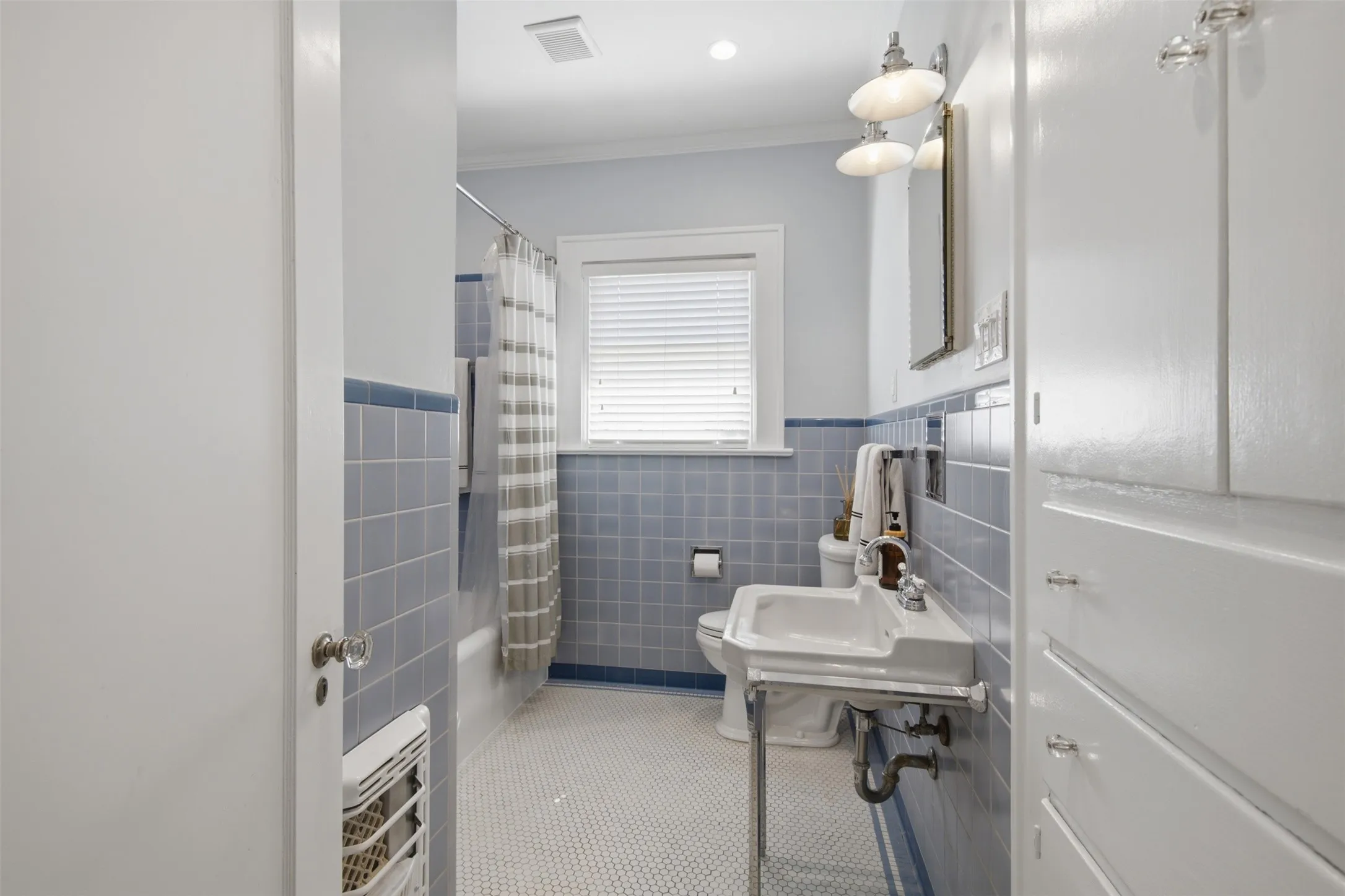 Second Bathroom featuring blue original tiled walls in vintage color, original tile flooring, and a pedestal sink