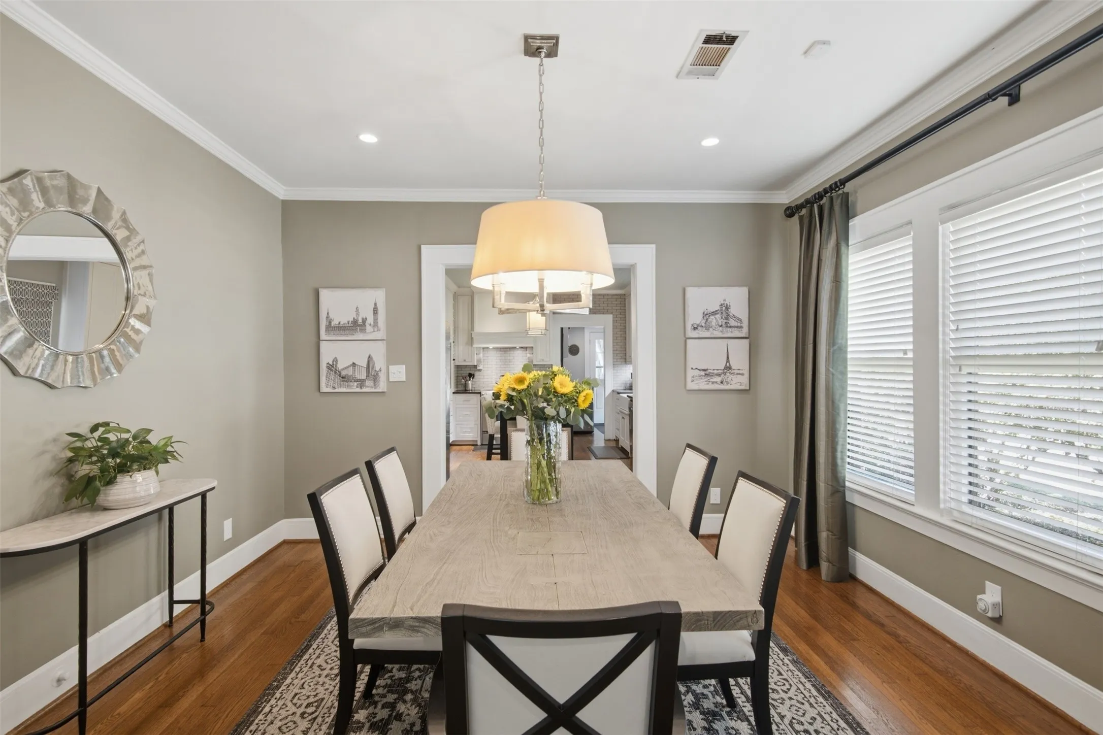 Hardwood flooring, recessed ceiling lighting, crown molding, and a chandelier with a drum shade