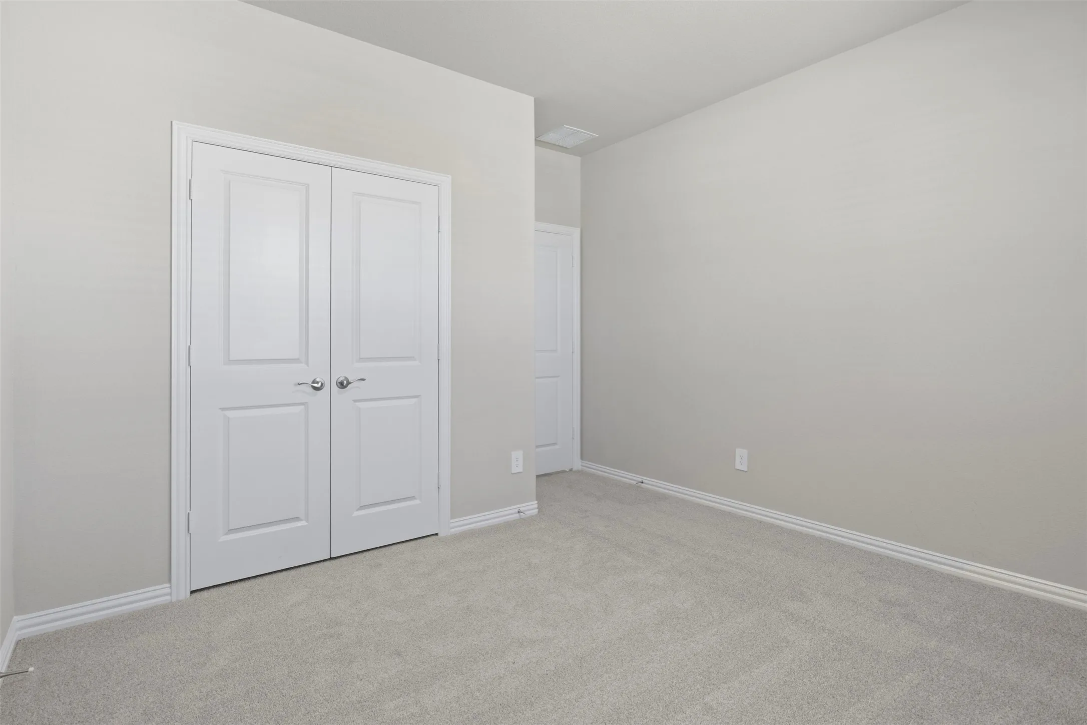 Neutral wall tones with light gray carpeting