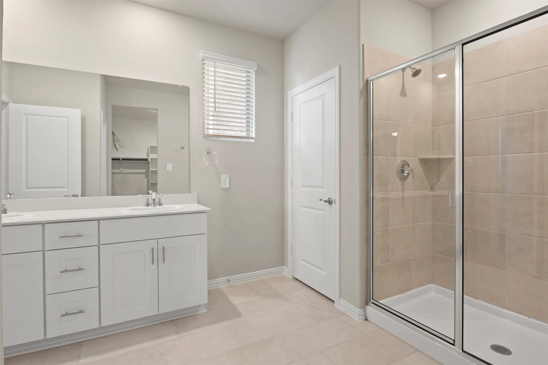 Dual vanity with undermount sinks, single-handle faucets, and white cabinetry