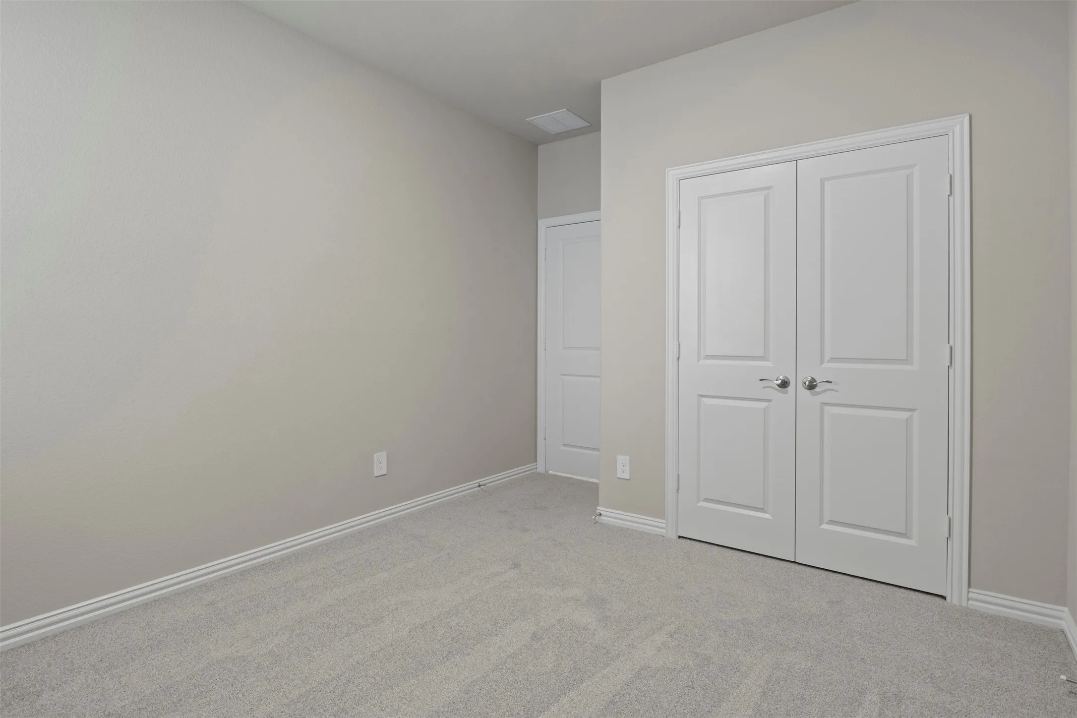 Neutral tone painted walls and plush carpeting