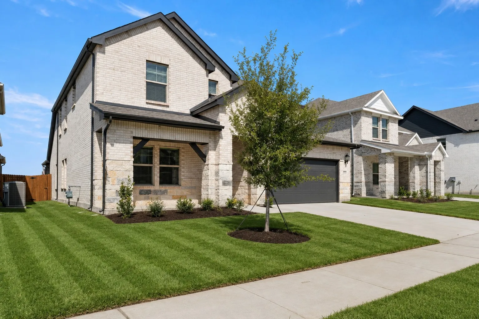 Cream brick exterior with stone accents and dark trim