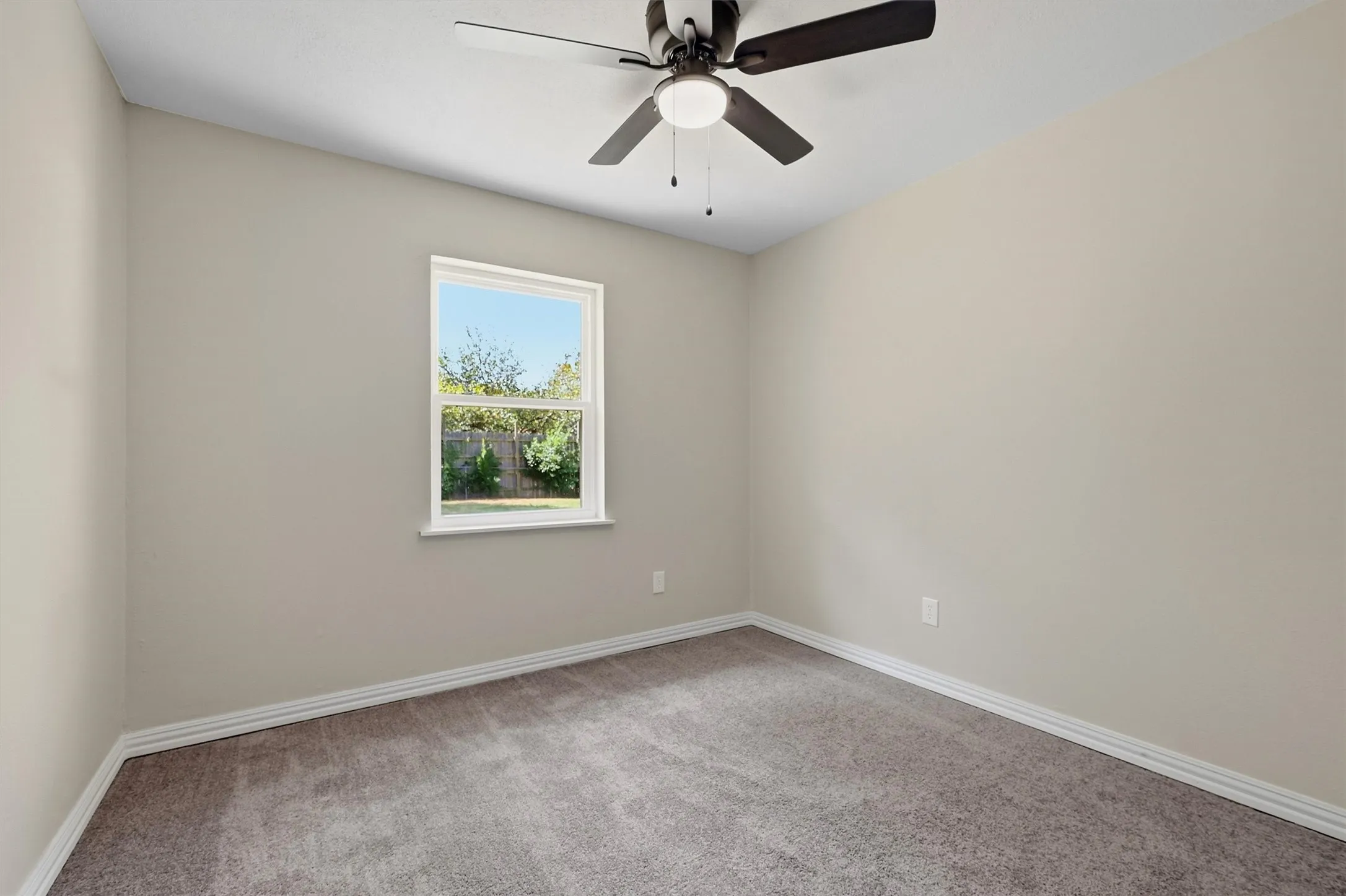 Neutral-toned walls complement the gray carpeting