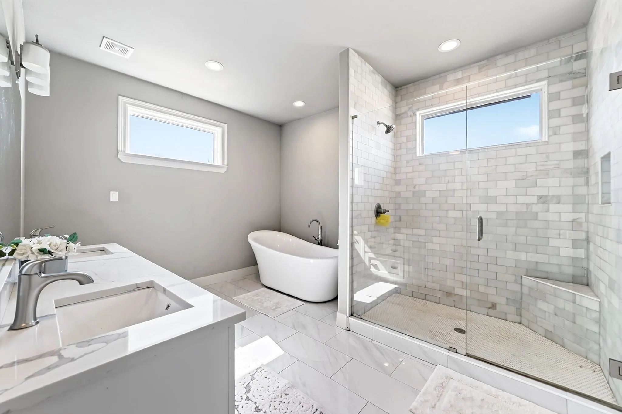 Dual vanity with undermount sinks and light-toned countertops