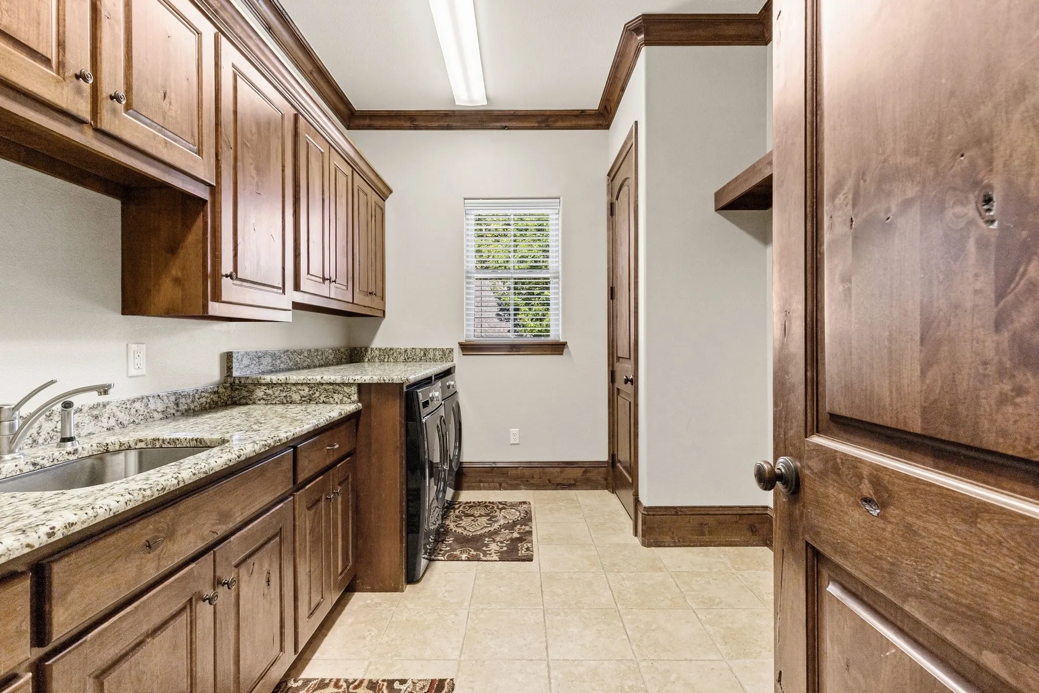 Spacious laundry room with 2 linen closets, sink and lots of storage.