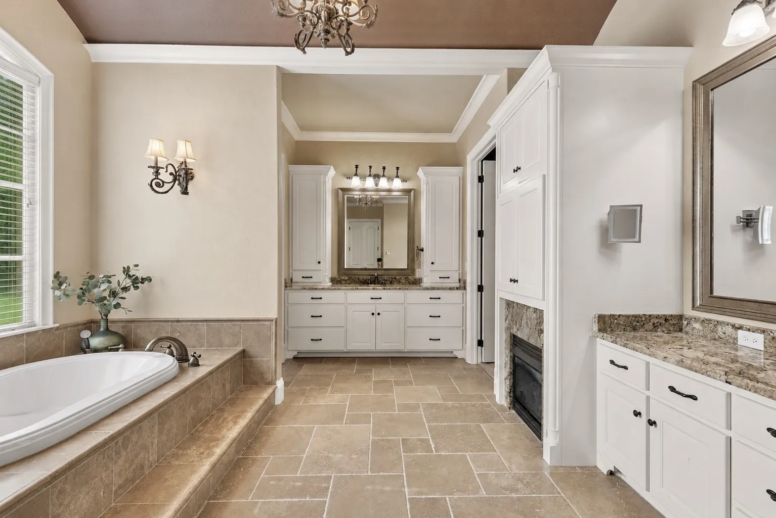 Private Primary Suite Retreat featuring a jetted tub, large walk-in tiled shower, dual vanities, spacious walk-in closet with built-ins, abundant storage, custom cabinetry, and a stunning circular domed ceiling accent.