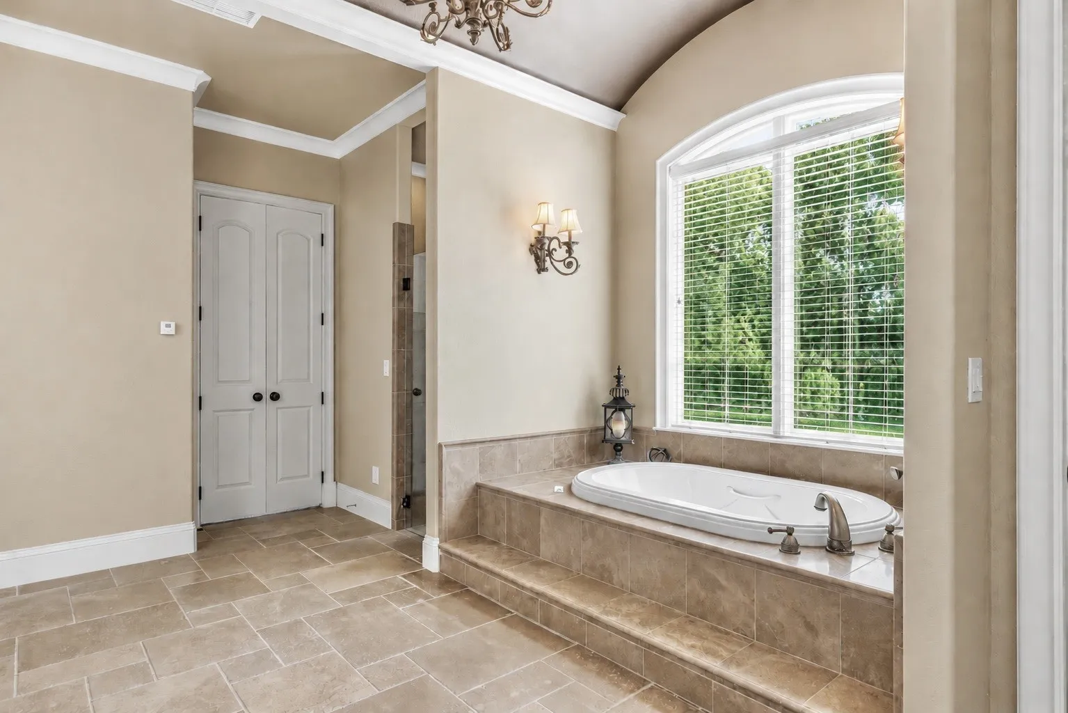 Private Primary Suite Retreat featuring a jetted tub, large walk-in tiled shower, dual vanities, spacious walk-in closet with built-ins, abundant storage, custom cabinetry, and a stunning circular domed ceiling accent.