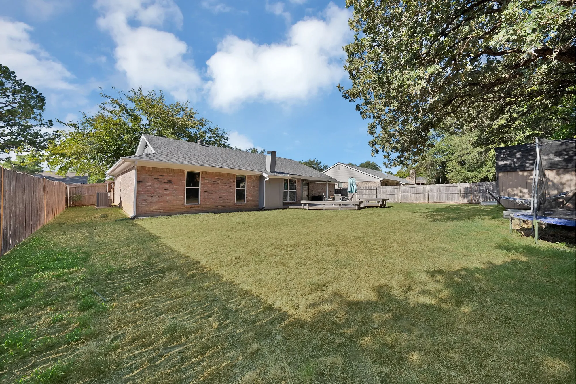 Expansive grass lawn with wood privacy fencing