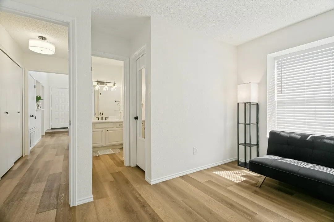 View of the Bathroom featuring a textured ceiling, hardwood / wood-style flooring, and vanity