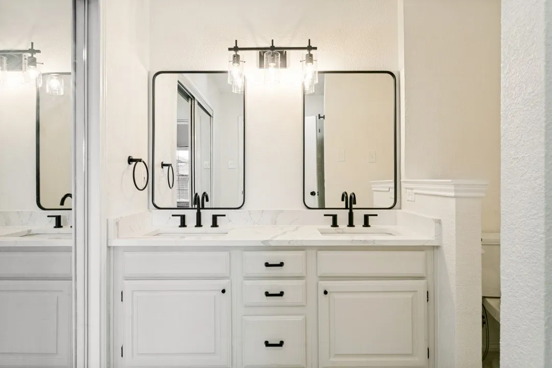 Bathroom with a textured ceiling and vanity
