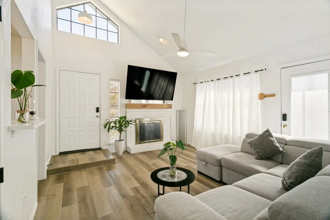Foyer entrance featuring a wealth of natural light, a fireplace, and dark hardwood / wood-style flooring