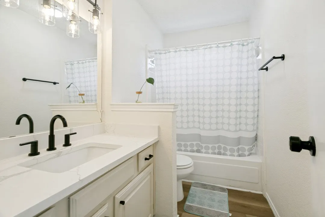 Bathroom featuring a textured ceiling, hardwood / wood-style flooring, and vanity
