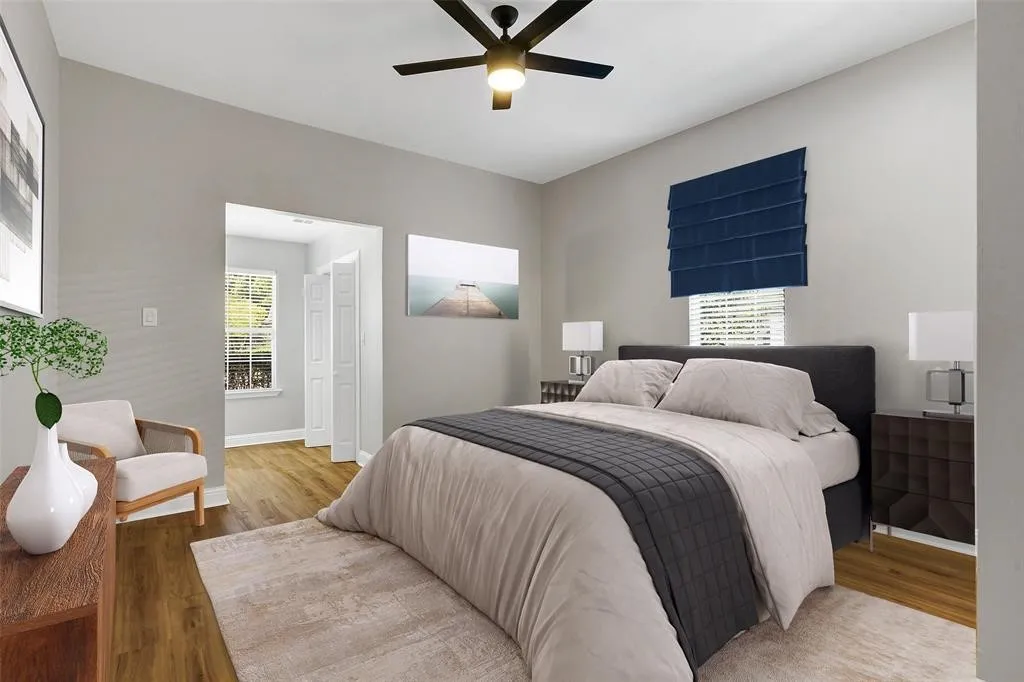 virtually staged primary bedroom with extra area that can used as a dressing room, sitting area, or office