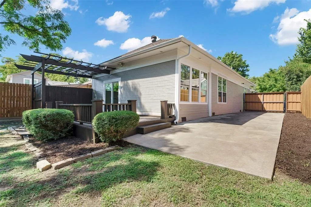 backyard with gated parking area and roomy deck
