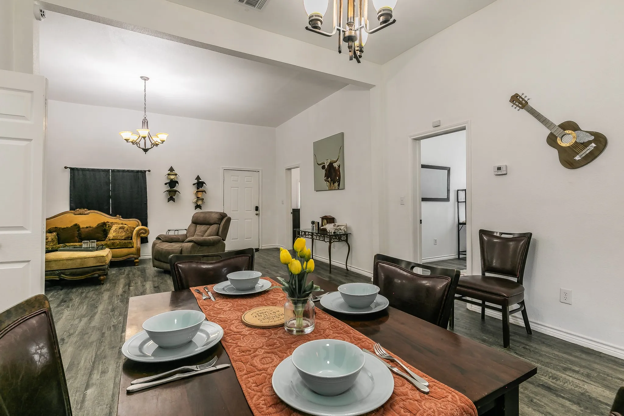 Vaulted ceiling with an exposed beam, wood-finish flooring, recessed lighting, and a chandelier lighting fixture