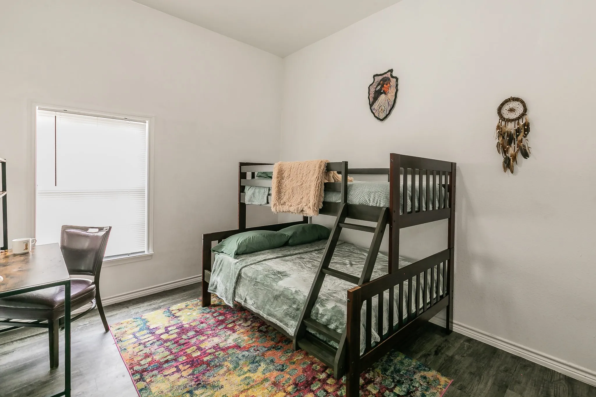 Wood-finish flooring with white baseboards