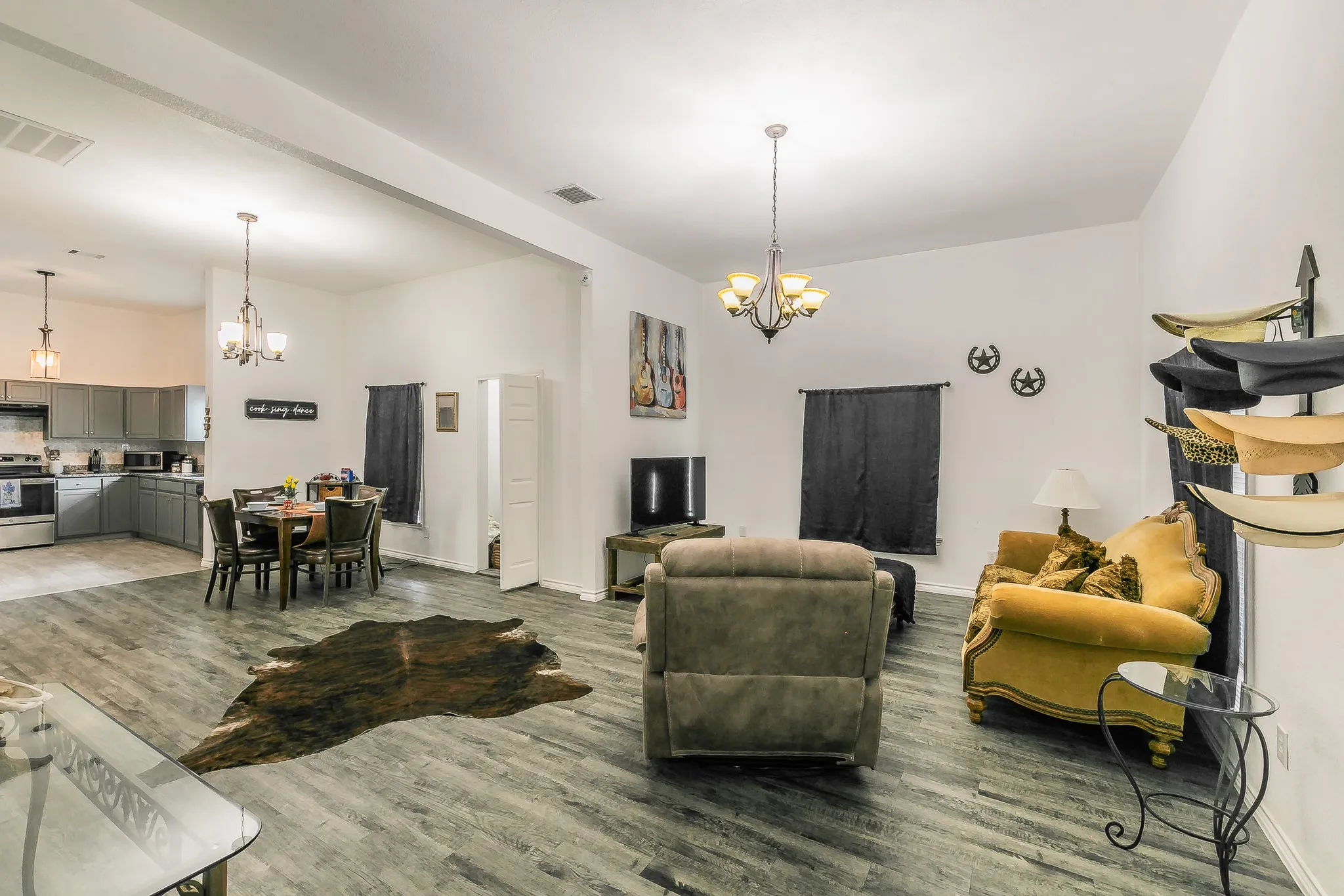 Spacious common area featuring wood-finish flooring, recessed lighting, and a chandelier