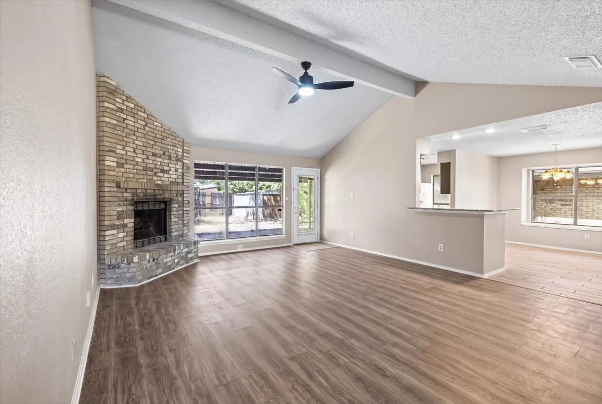 Living room with breakfast bar open to the kitchen and dining room