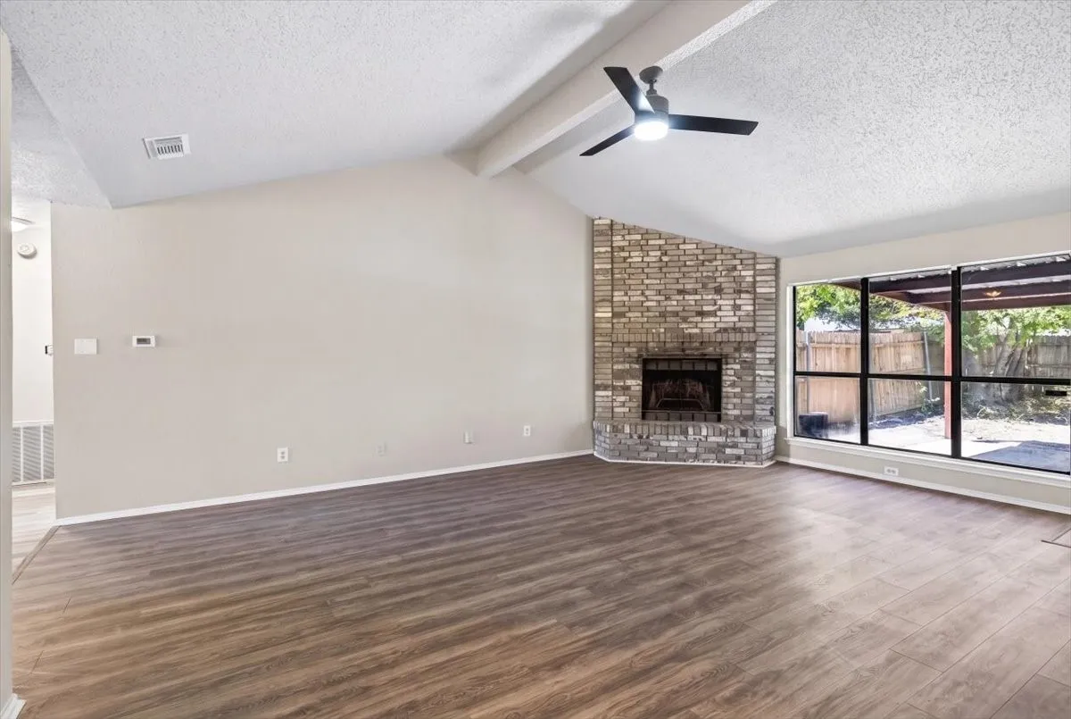 Living room with lots of windows for natural light and corner cozy fireplace