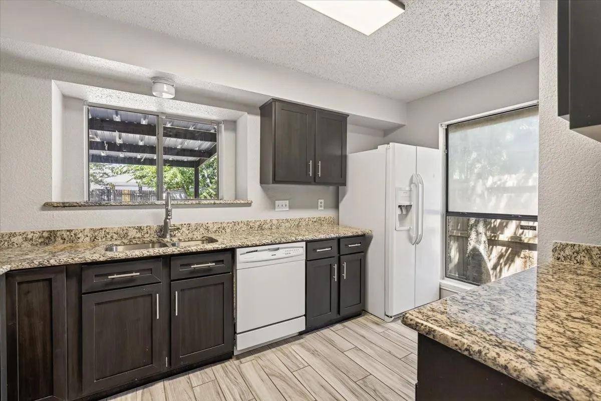 Another view of the kitchen  showing lots of natural light