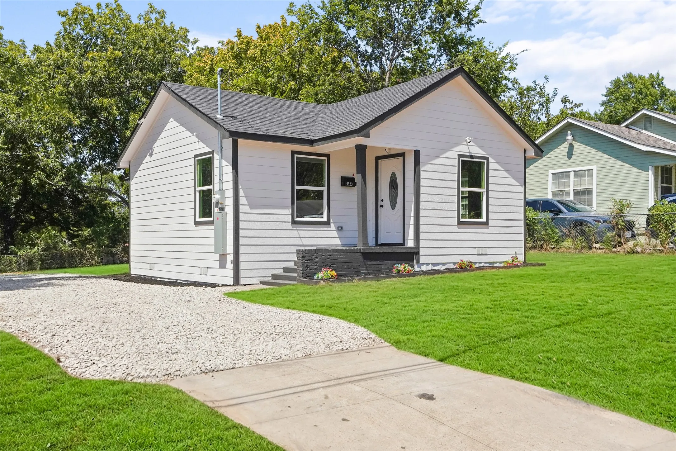 White siding exterior with ai generated turf