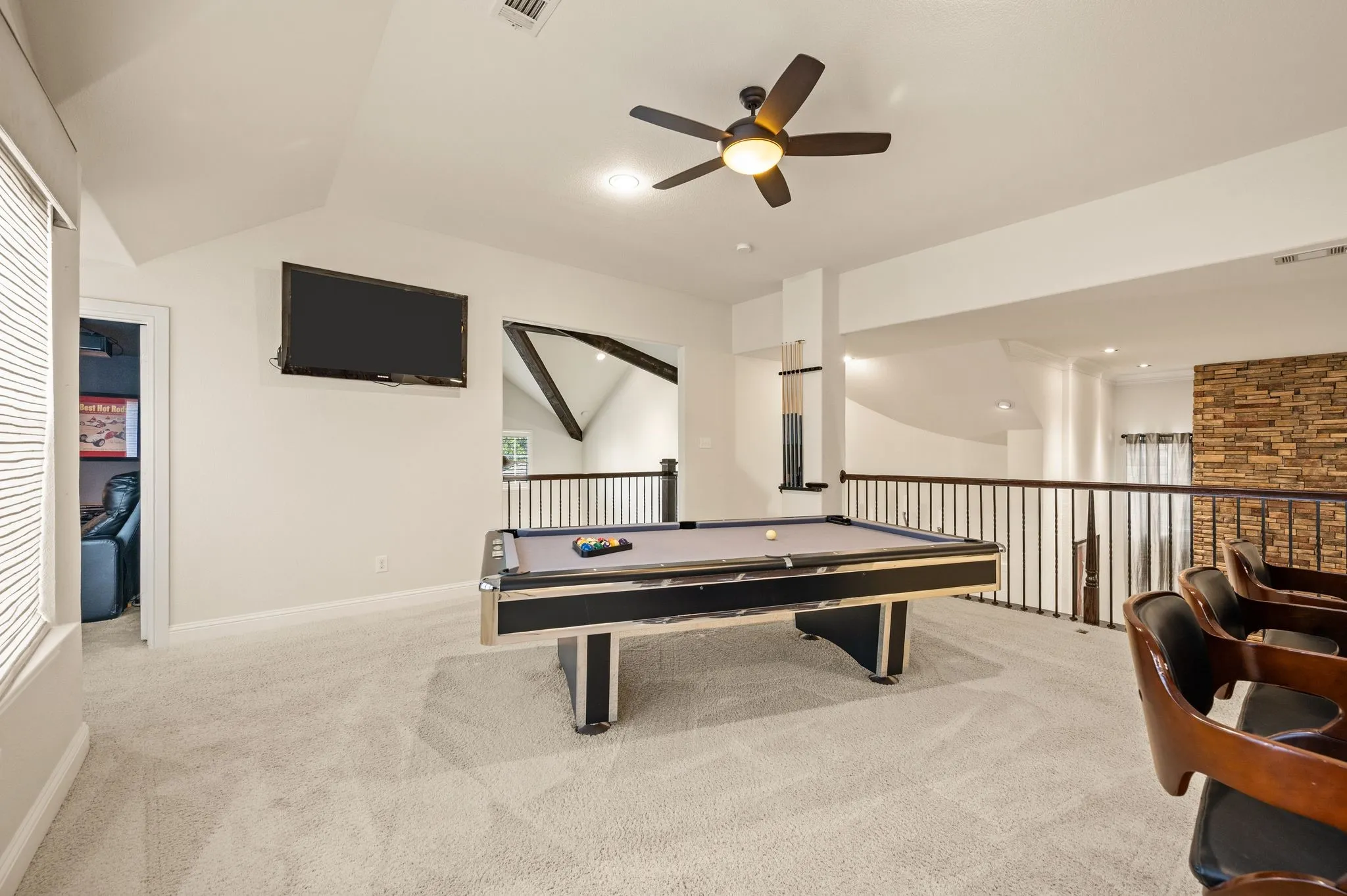 Loft space featuring sloped ceilings, recessed lighting, and a ceiling fan