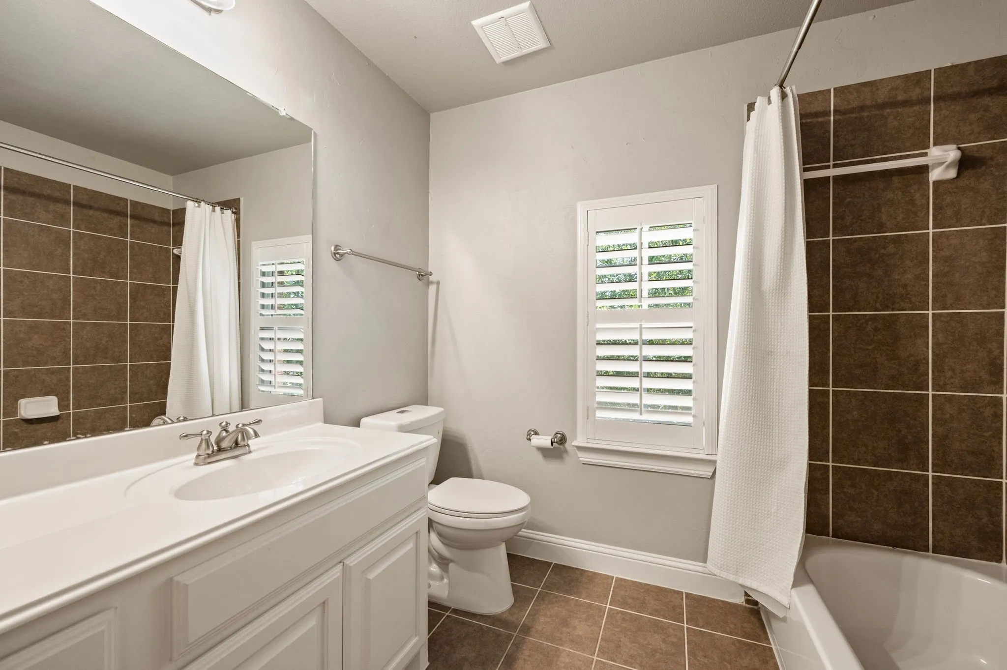 White vanity with an integrated sink and brushed nickel faucet