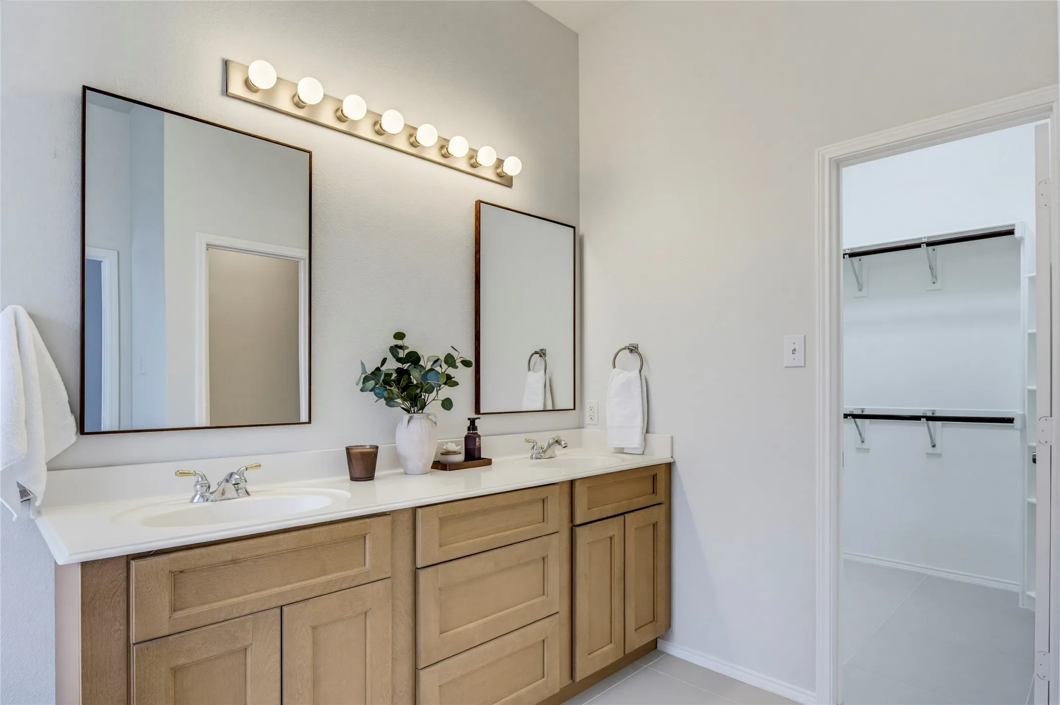 Bathroom updates include fresh paint, the wood vanity, mirrors, and beautiful tile floor.