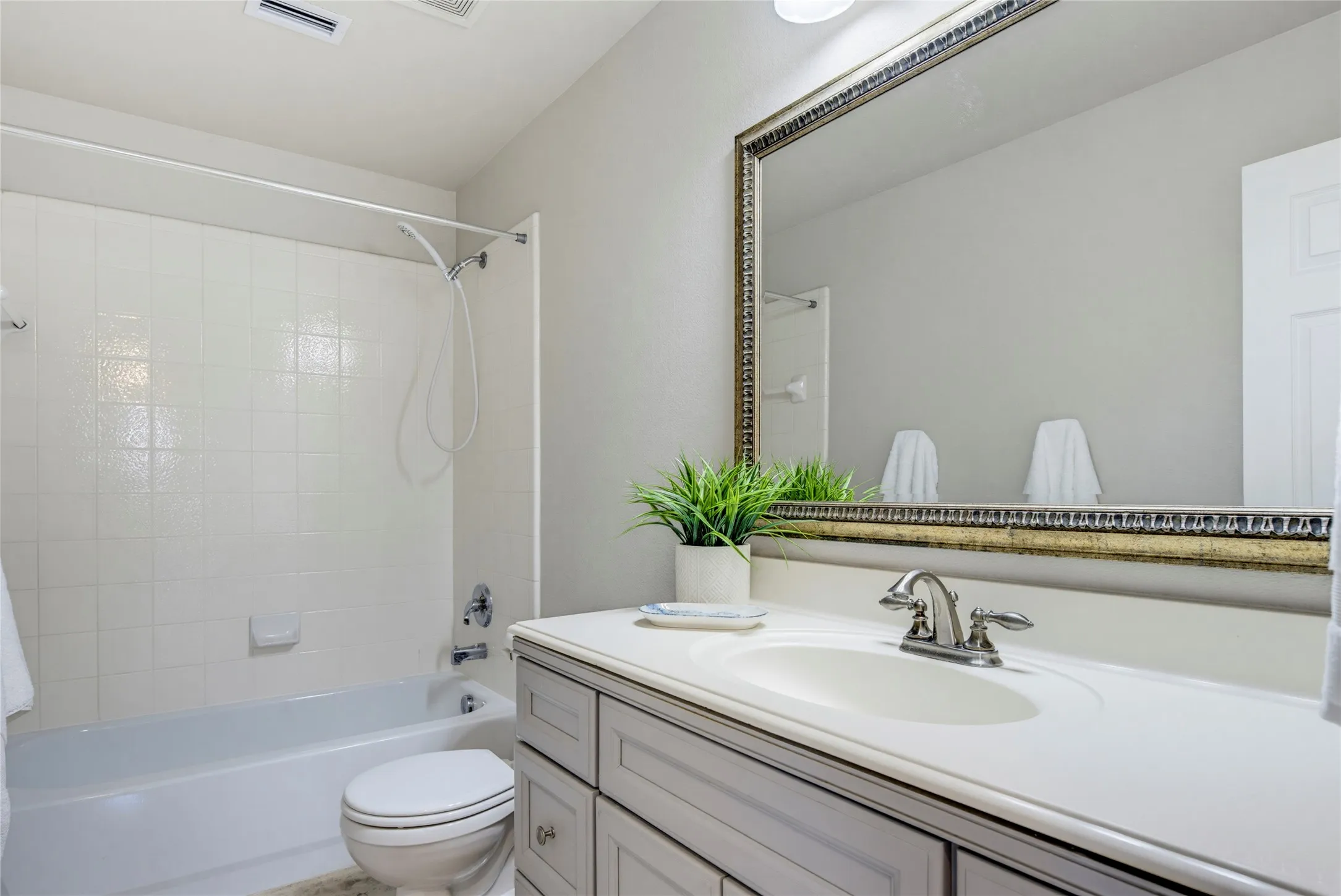 Bathroom updates include the wood vanity, fresh paint, and tile flooring.
