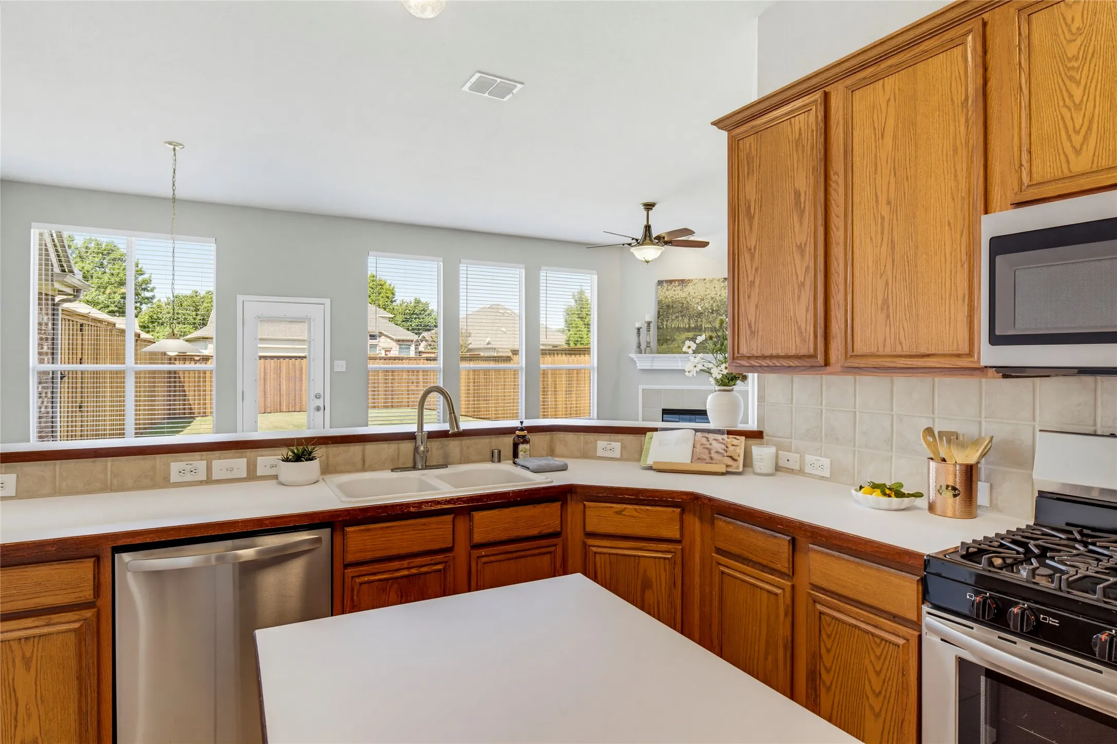 The kitchen is open to the breakfast room and living room and enjoys views of the backyard as well.