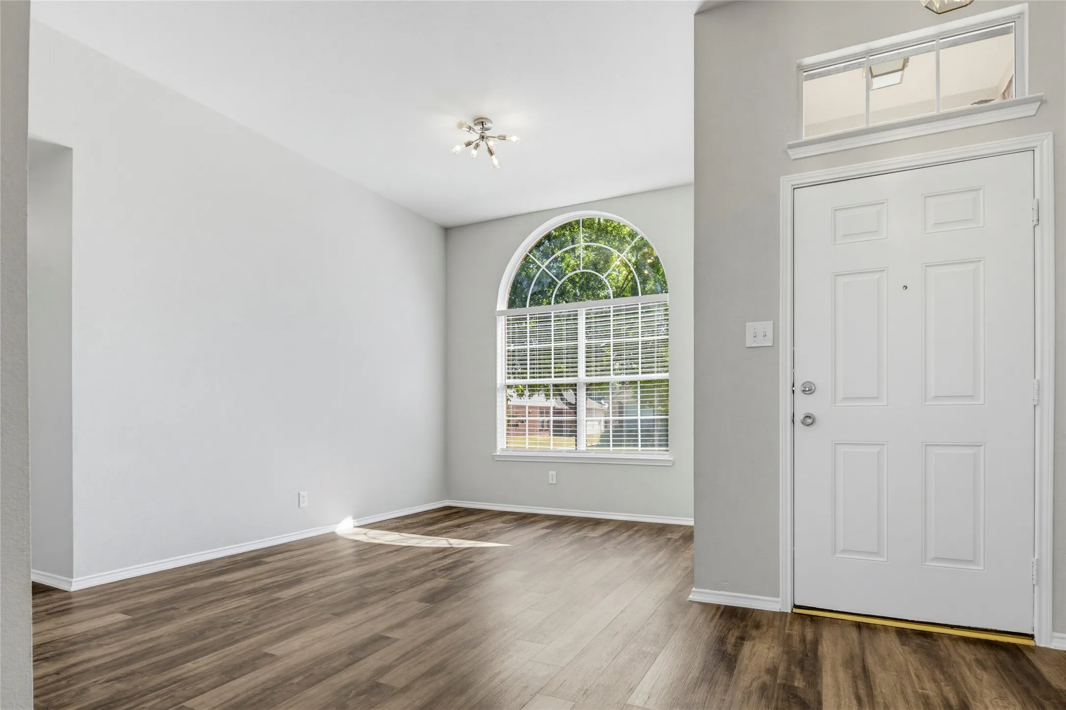 The entry is flanked by the dining room and formal living room.  LVP flooring extends throughout the main areas of the home and into the bedrooms.