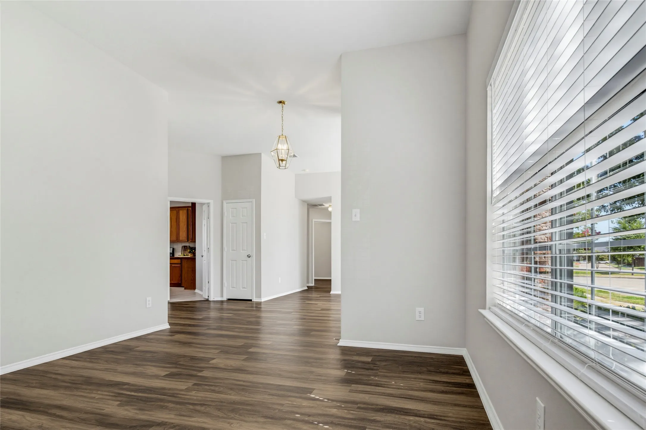 View from formal living room looking toward the kitchen and the hallway with the 3 secondary bedrooms.