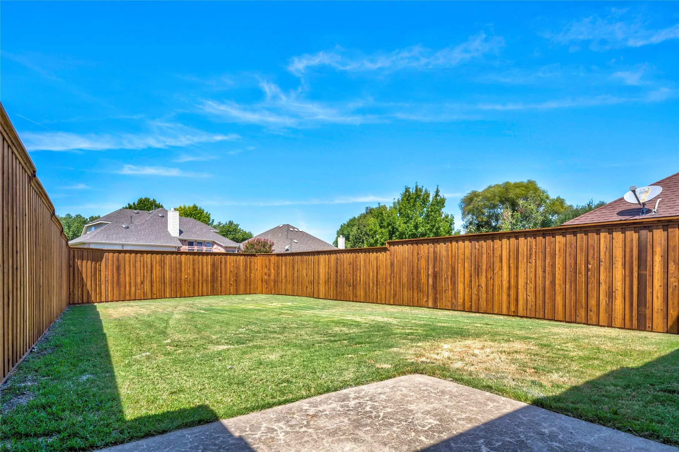 Flat, grassy yard and August 2026 8-foot board-on-board cedar fence!