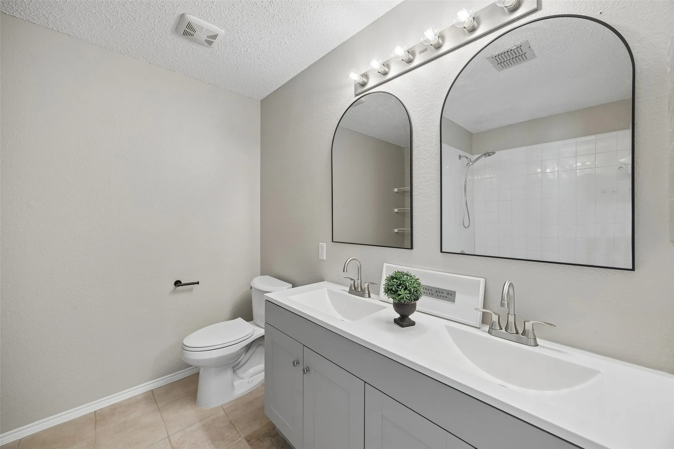 Duel sinks with fresh countertops, cabinets, mirrors and fixtures