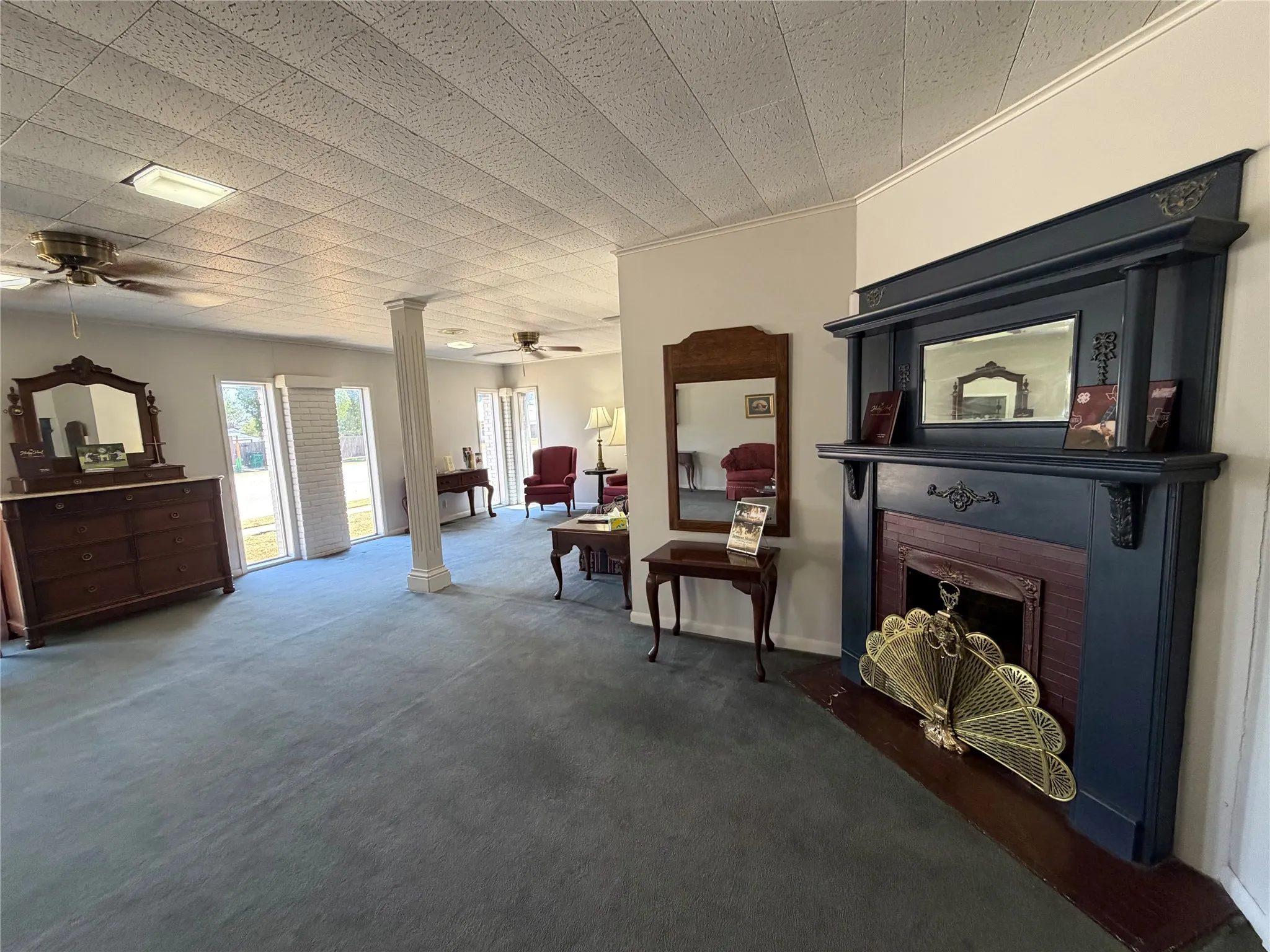 Decorative fireplace with mantel, recessed fireplace insert, and brick surround