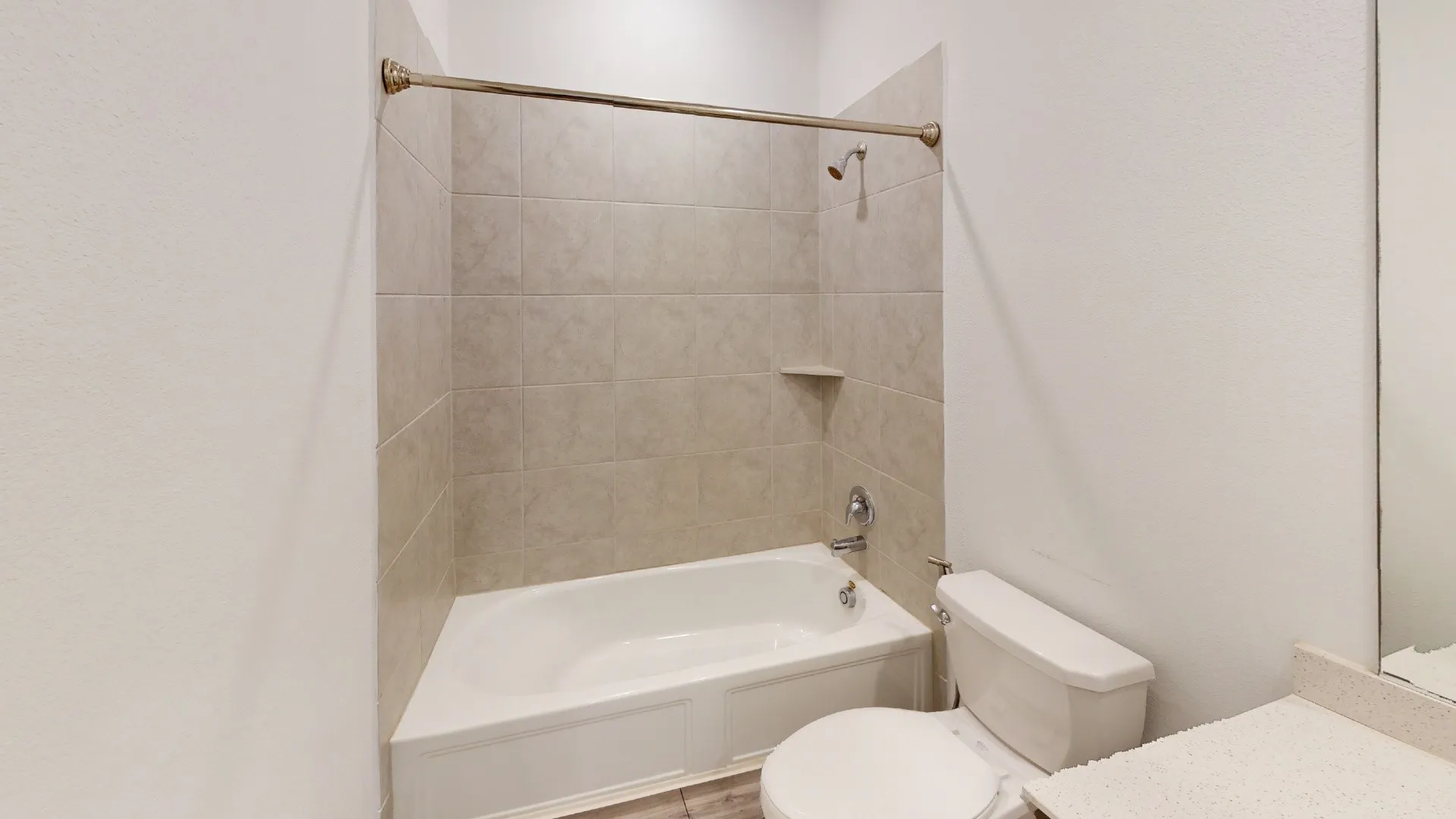 Bathtub and shower combination with tile surround and built-in niche
