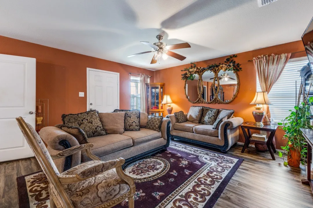 Wood-finish flooring throughout, complemented by a ceiling fan with integrated lighting
