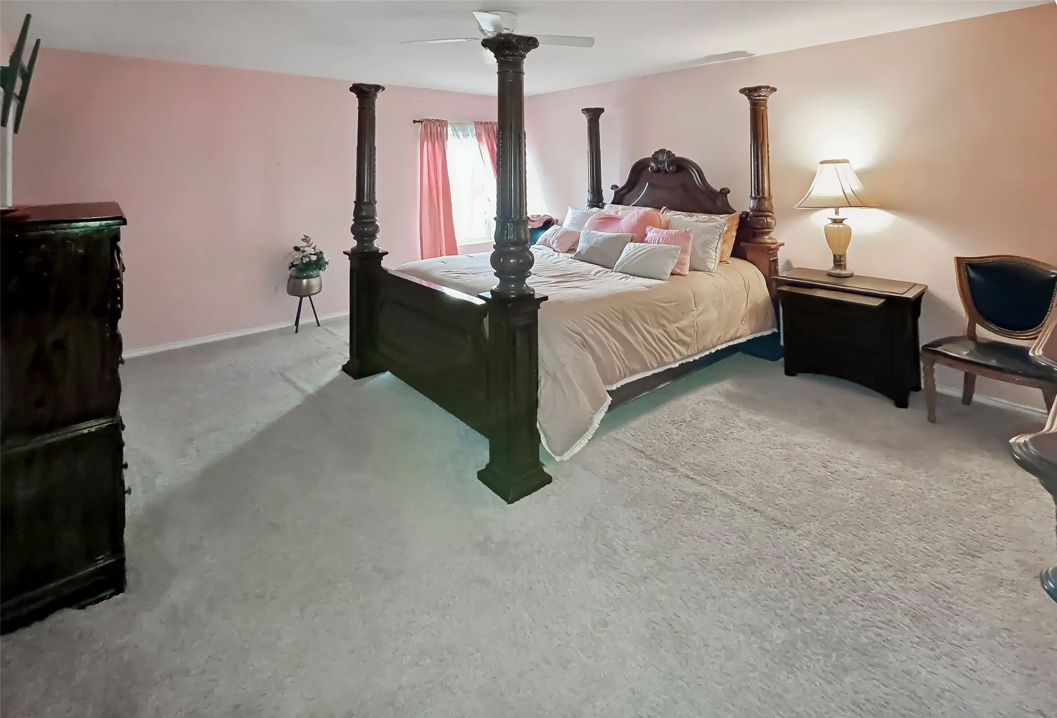 Wall-to-wall carpeting with light-colored walls and a ceiling fan