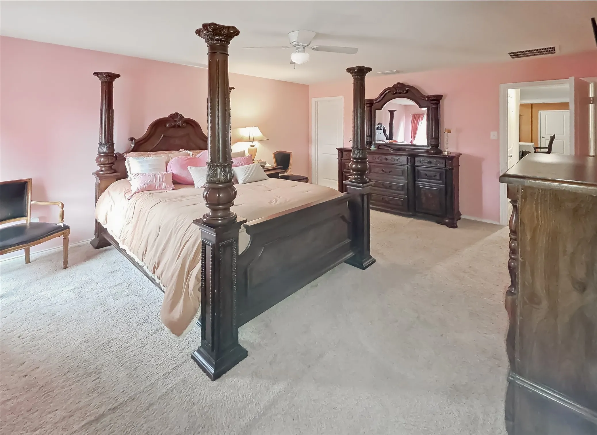 Wall-to-wall carpeting, ceiling fan, and painted walls