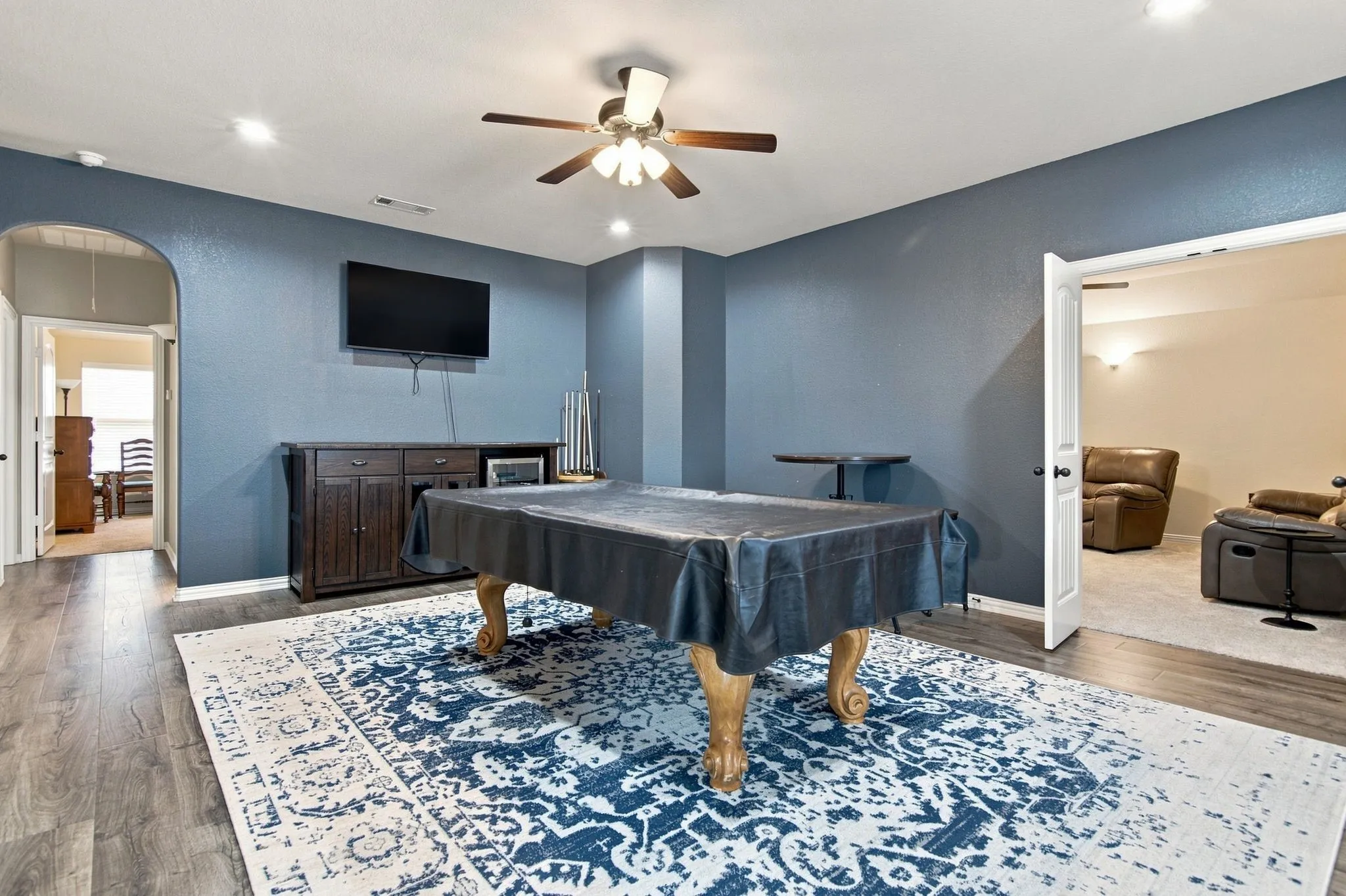 Upstairs game room/living area with media room adjacent.  Three additional upstairs bedrooms beyond this area