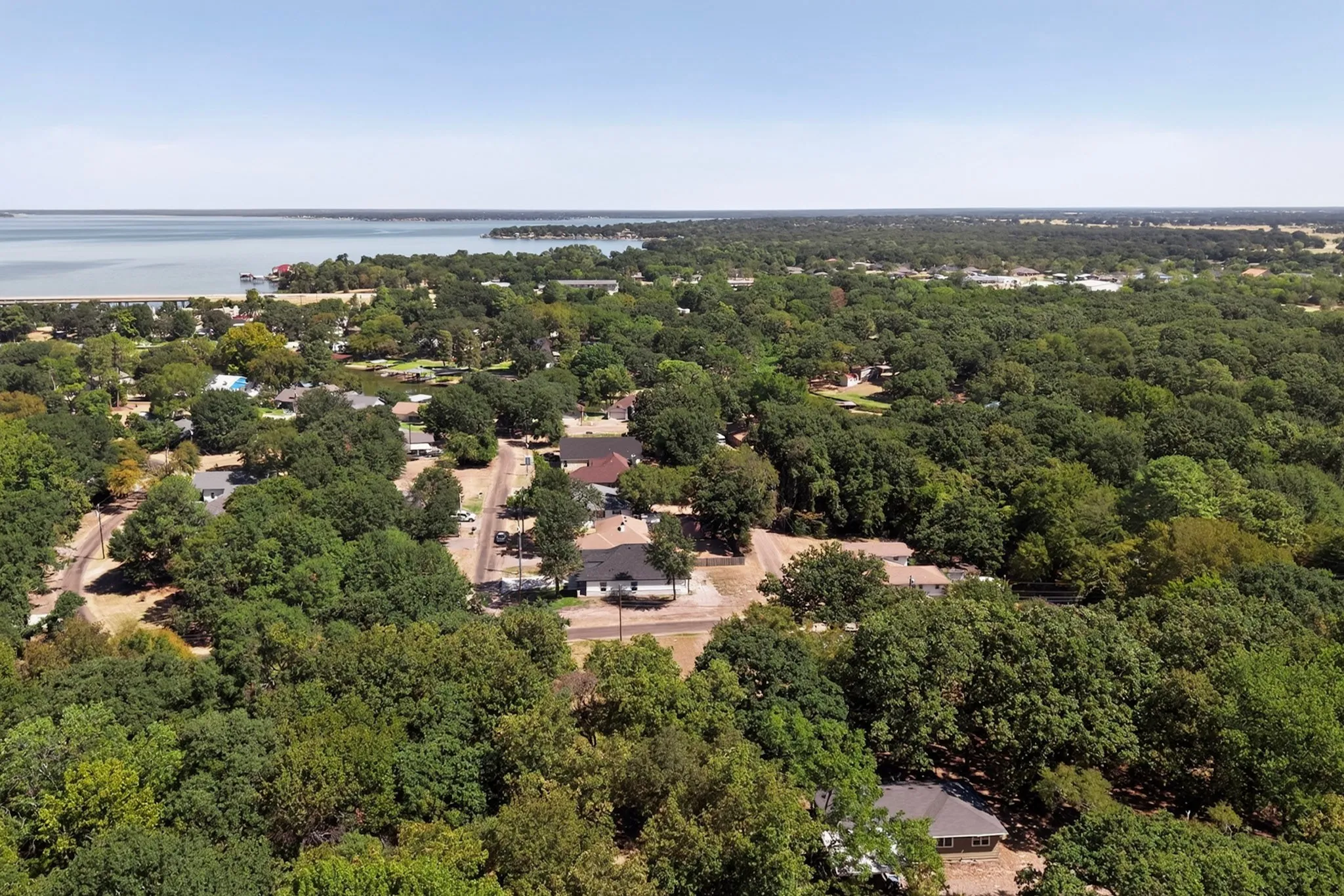 Expansive treed landscape with a visible waterfront