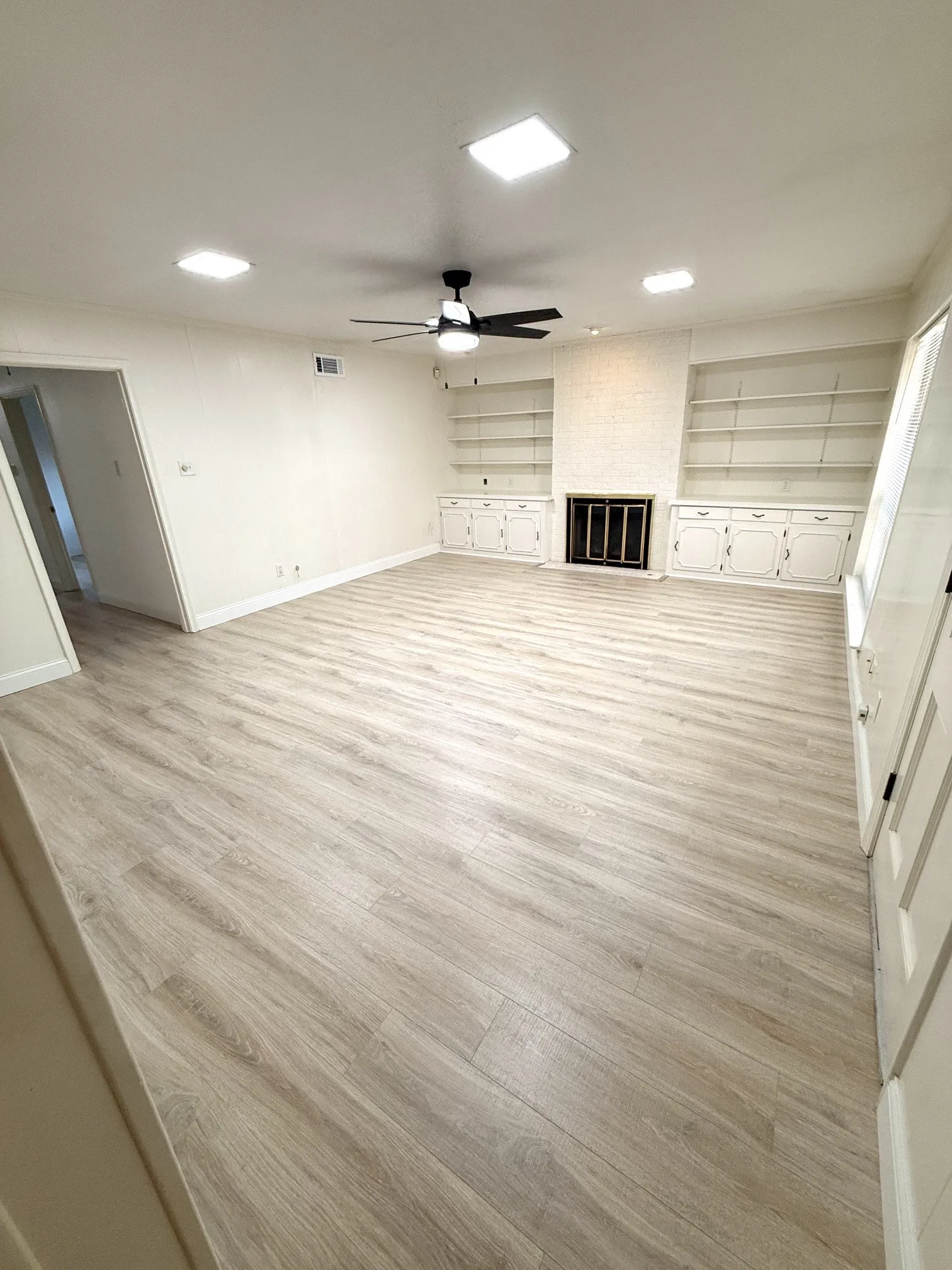 Den with gas log fireplace and built-ins