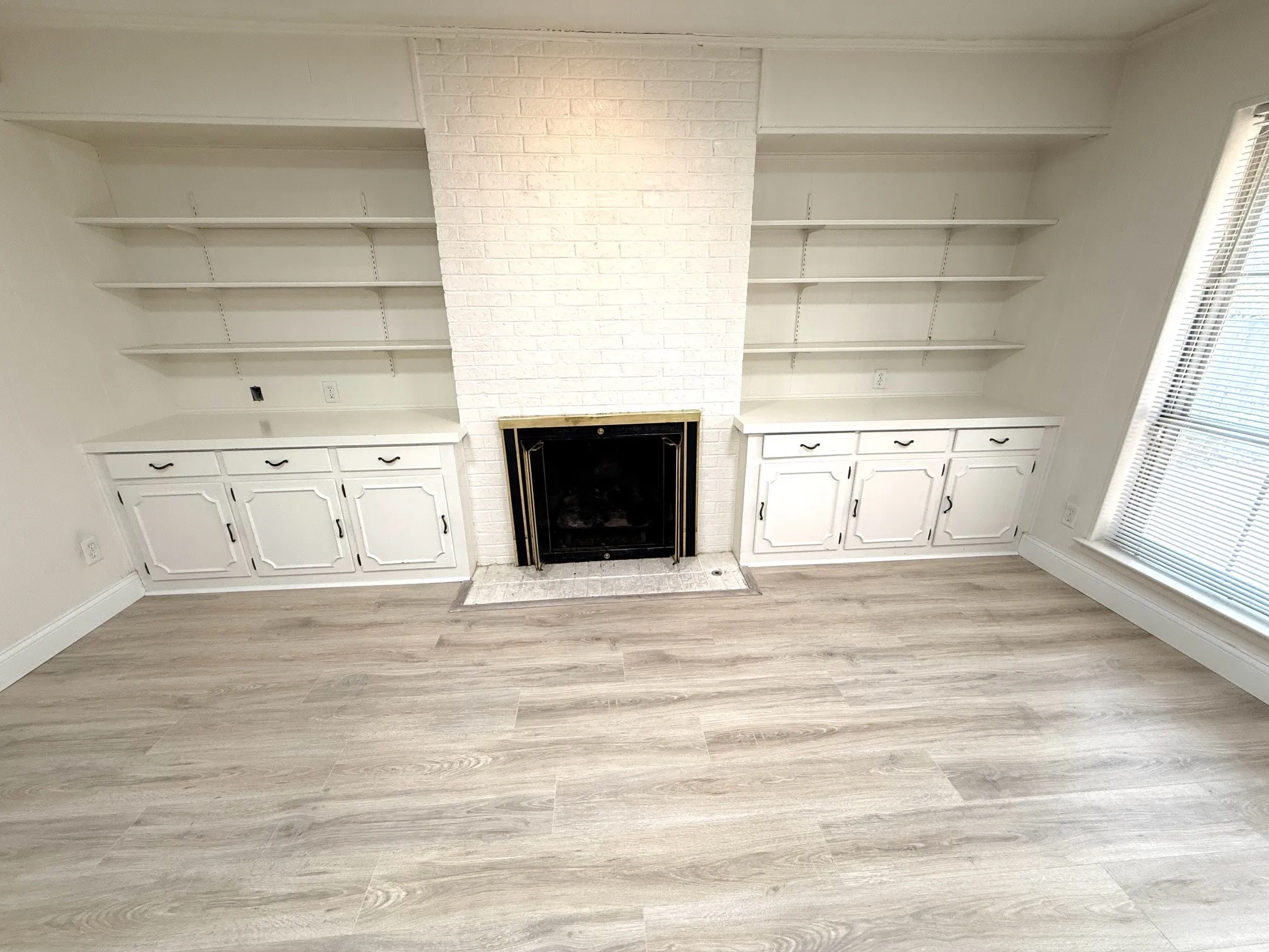 Den with gas log fireplace and built-ins