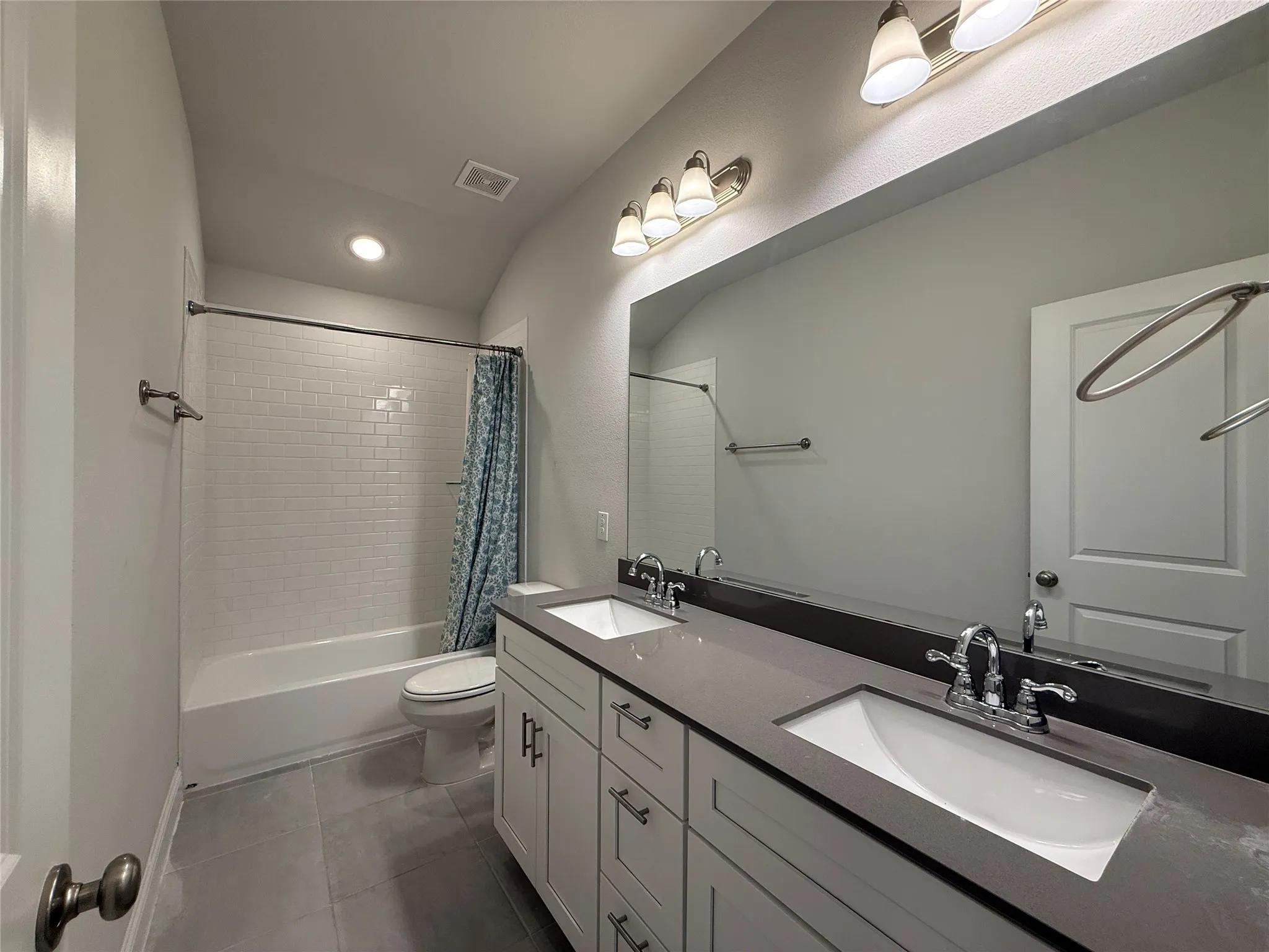 Double vanity with integrated sinks and gray countertop