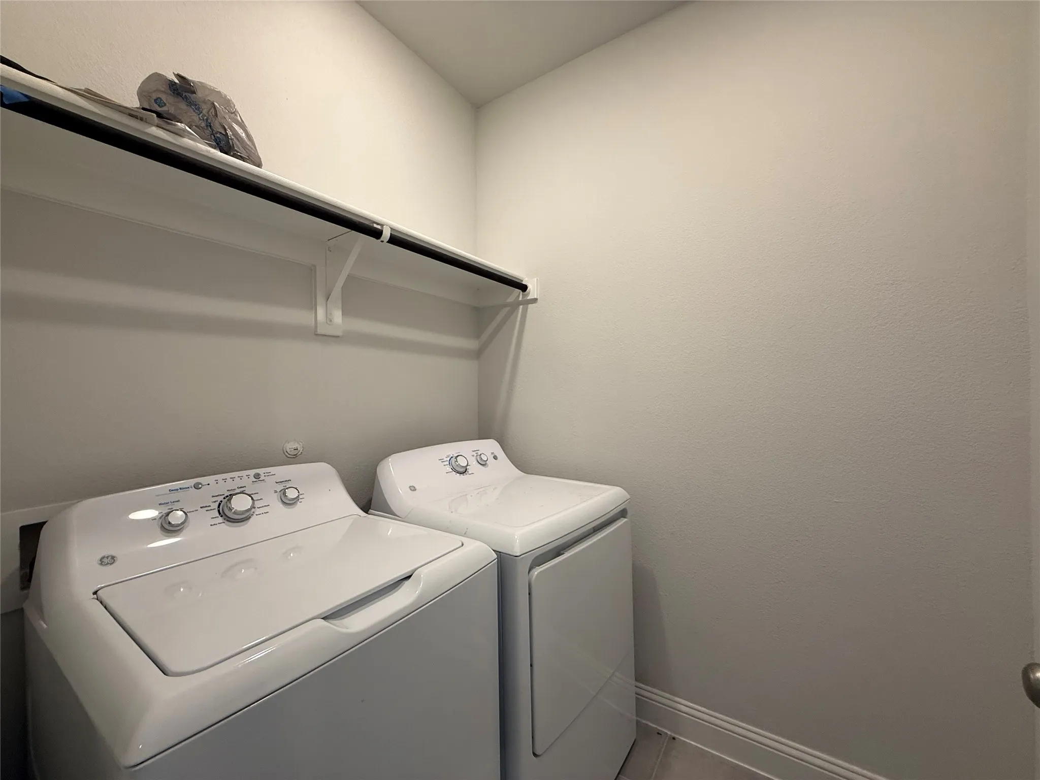 Laundry area with built-in shelving and hanging rod