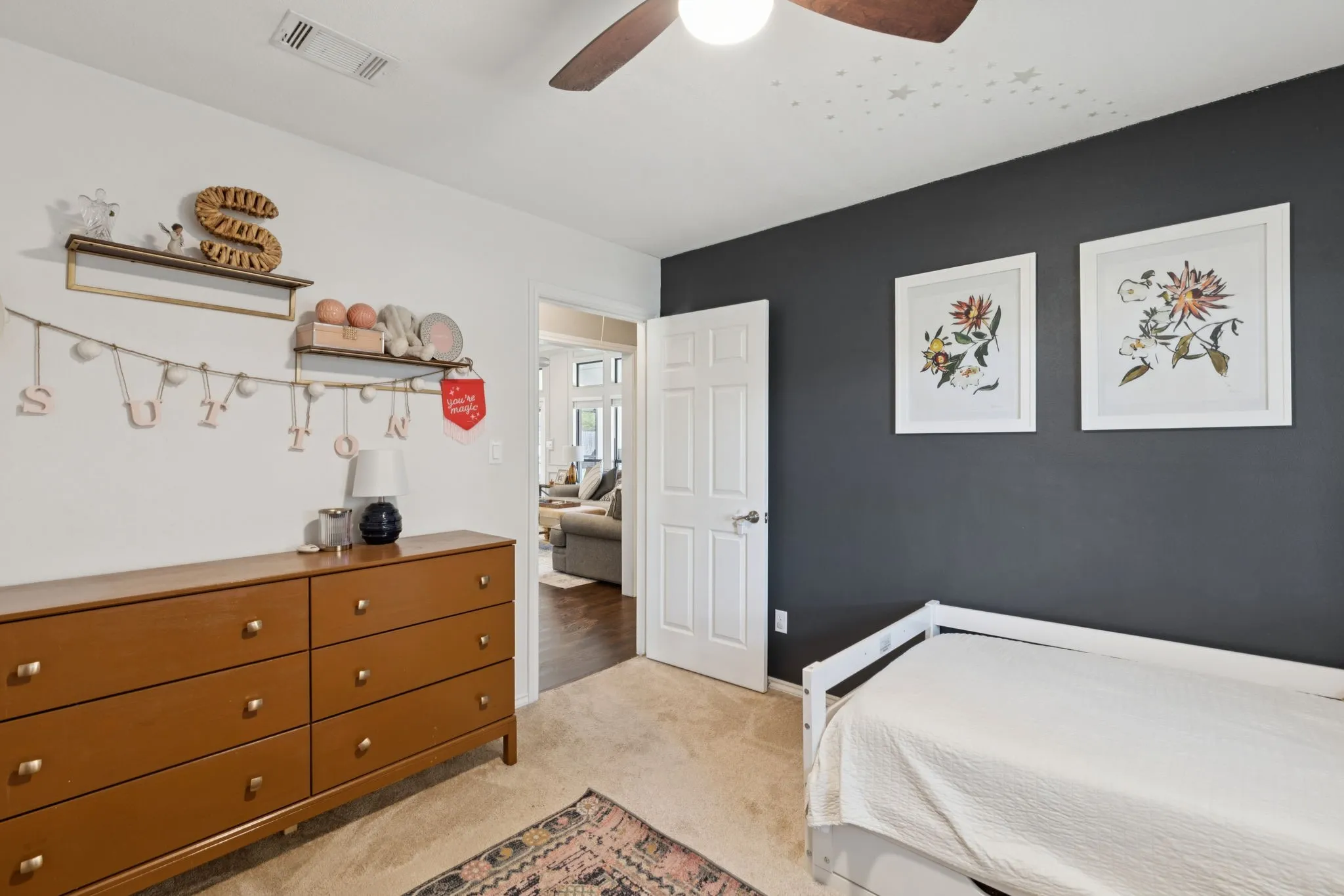 Recessed lighting, ceiling fan, white paneled door, and two-tone wall treatment